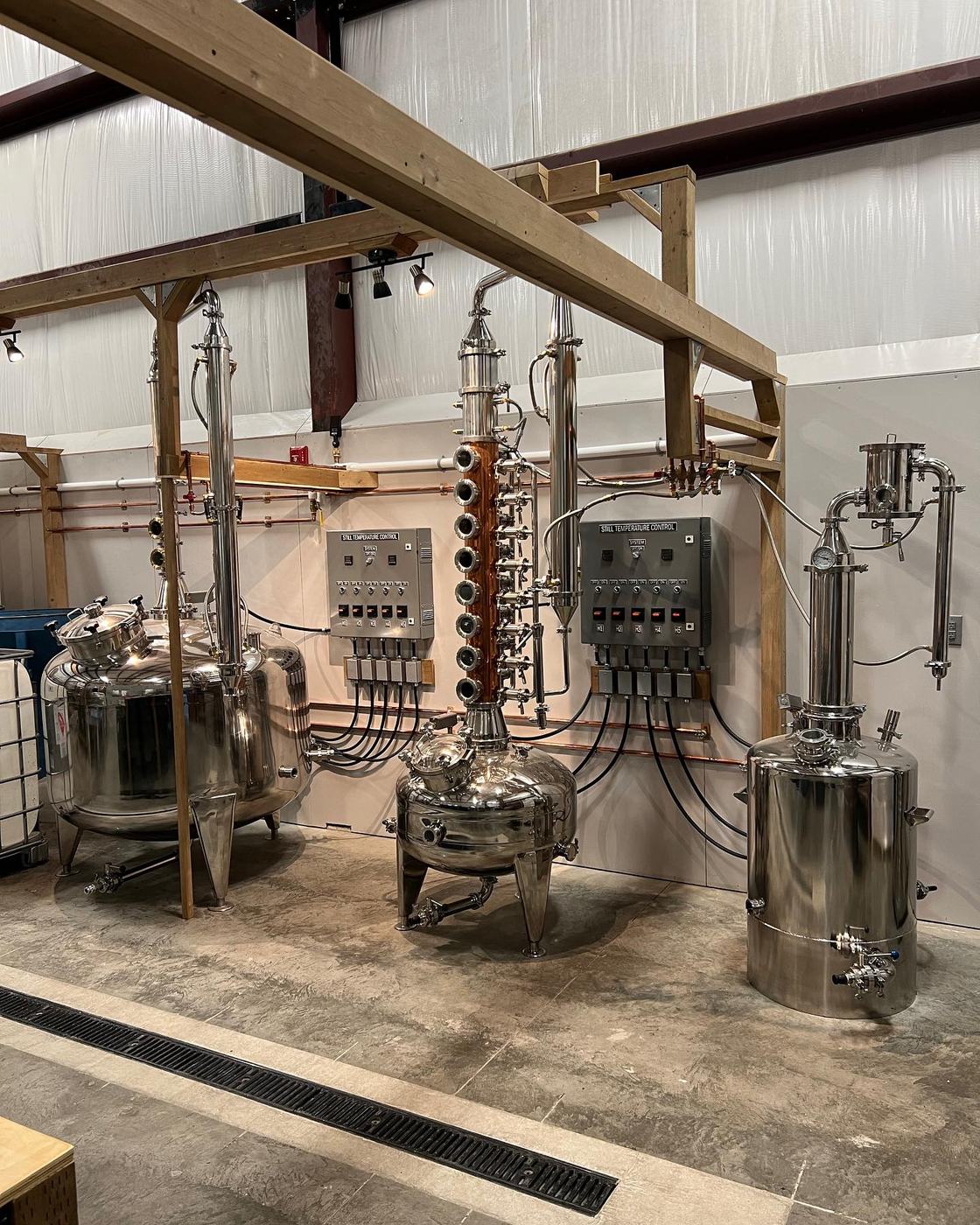 Commercial distillery equipment wired with overhead cable tray
